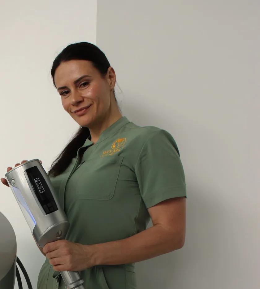A WO/MAN specialist holding a body treatment handpiece in a private room