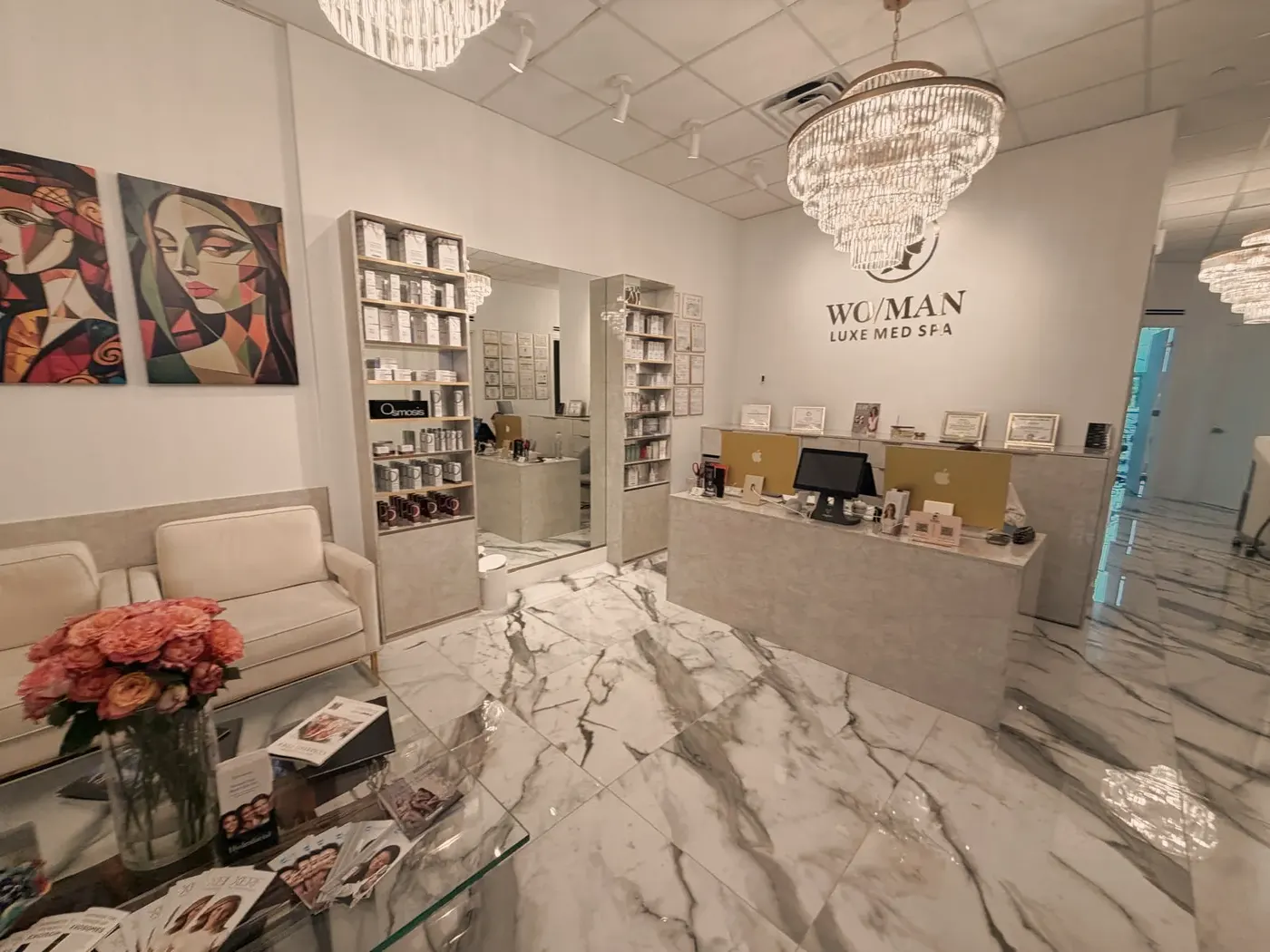 The marble reception desk under a crystal chandelier